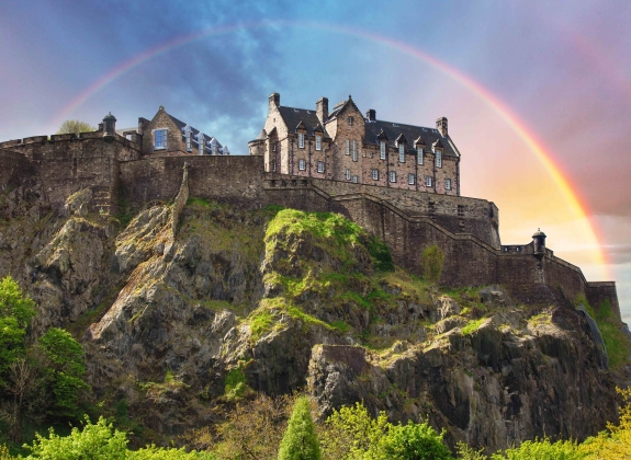 Scotland - Rainbow over Edinburgh Castle with green garden, UK