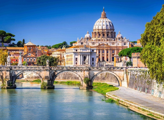 St. Peter's Basilica in Vatican City, as seen across the Tiber River in Rome, Italy