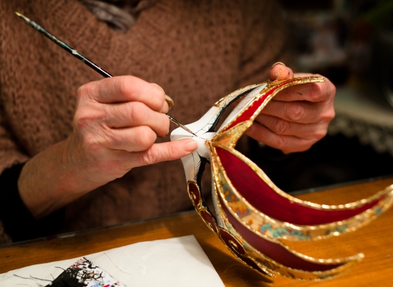 Woman hands with venice carnival mask, painting, making of mask decoration