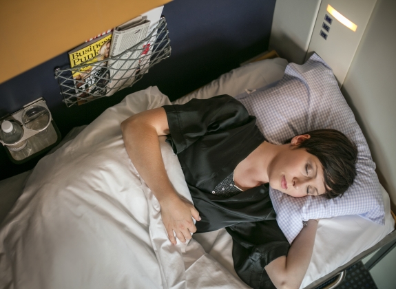 woman sleeping in NightJet train in Europe