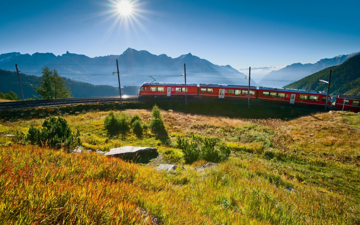 The Bernina Express A train travels up a mountain through the Alps