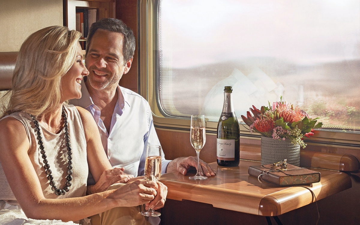 Onboard the Indian Pacific A couple share a bottle of champagne onboard the train