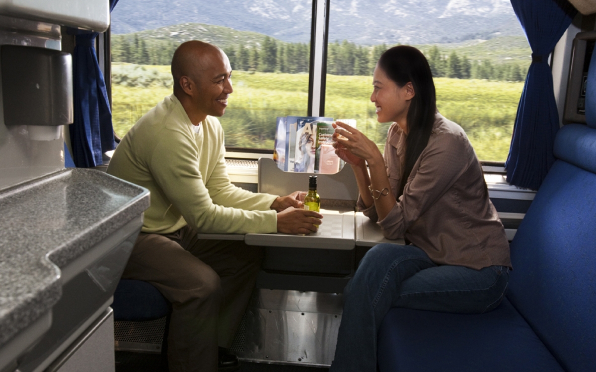 couple relaxing in an amtrak private bedroom