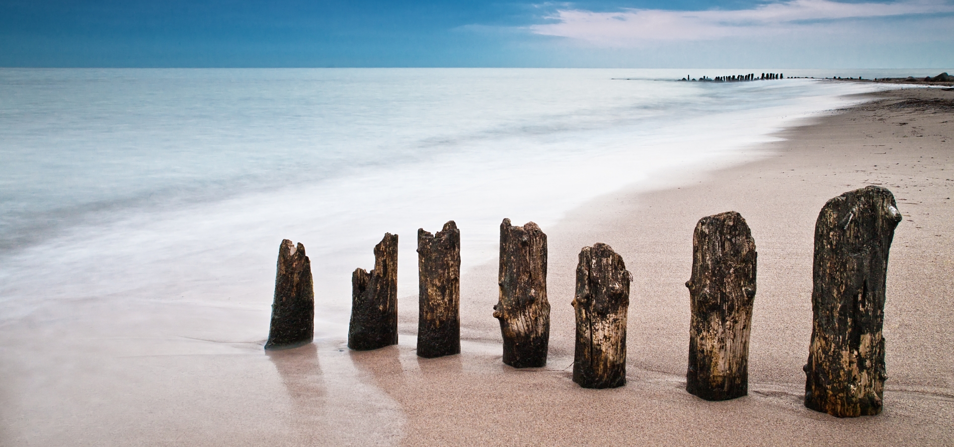 Groynes on shore of the Baltic Sea in Kuehlungsborn, Germany.