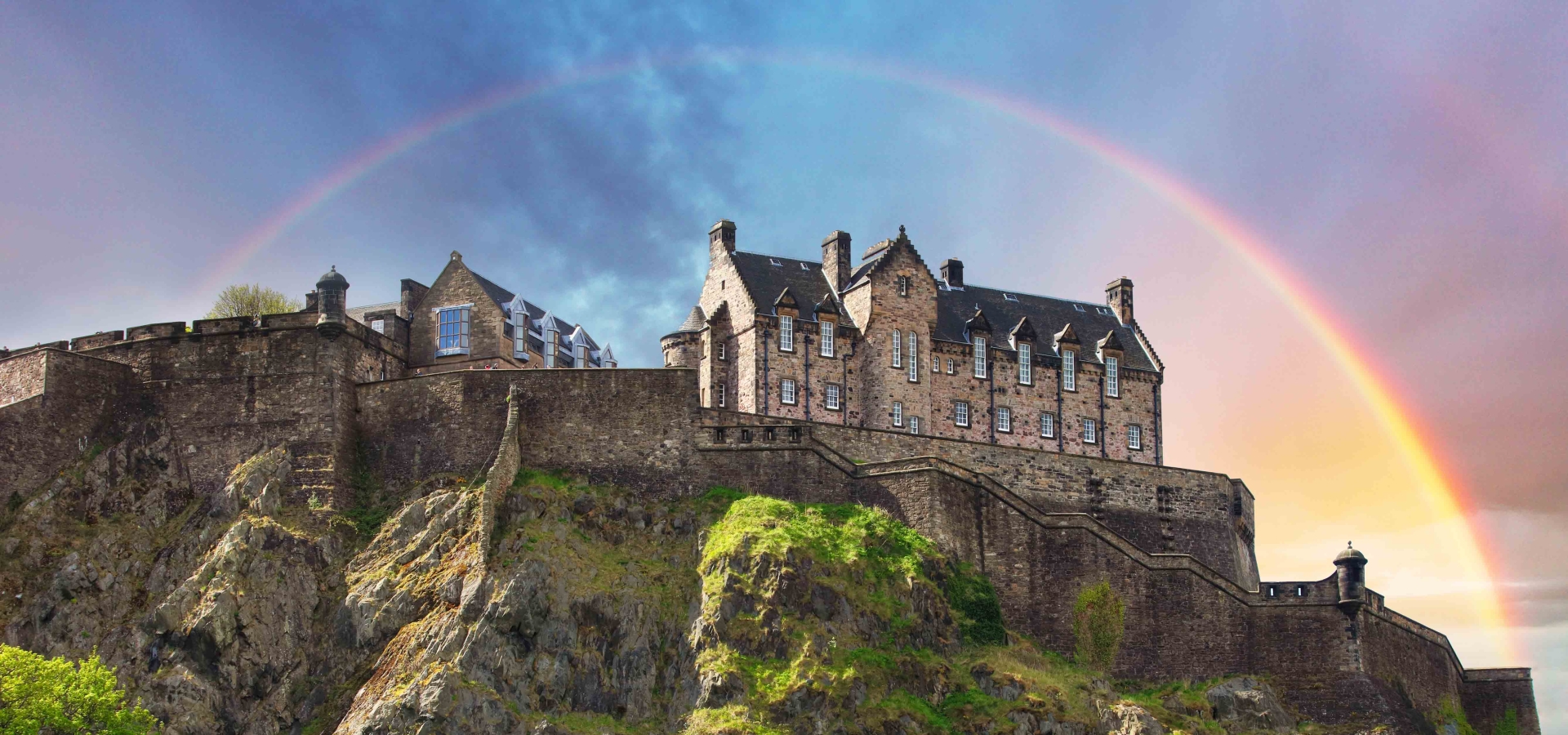 Scotland - Rainbow over Edinburgh Castle with green garden, UK