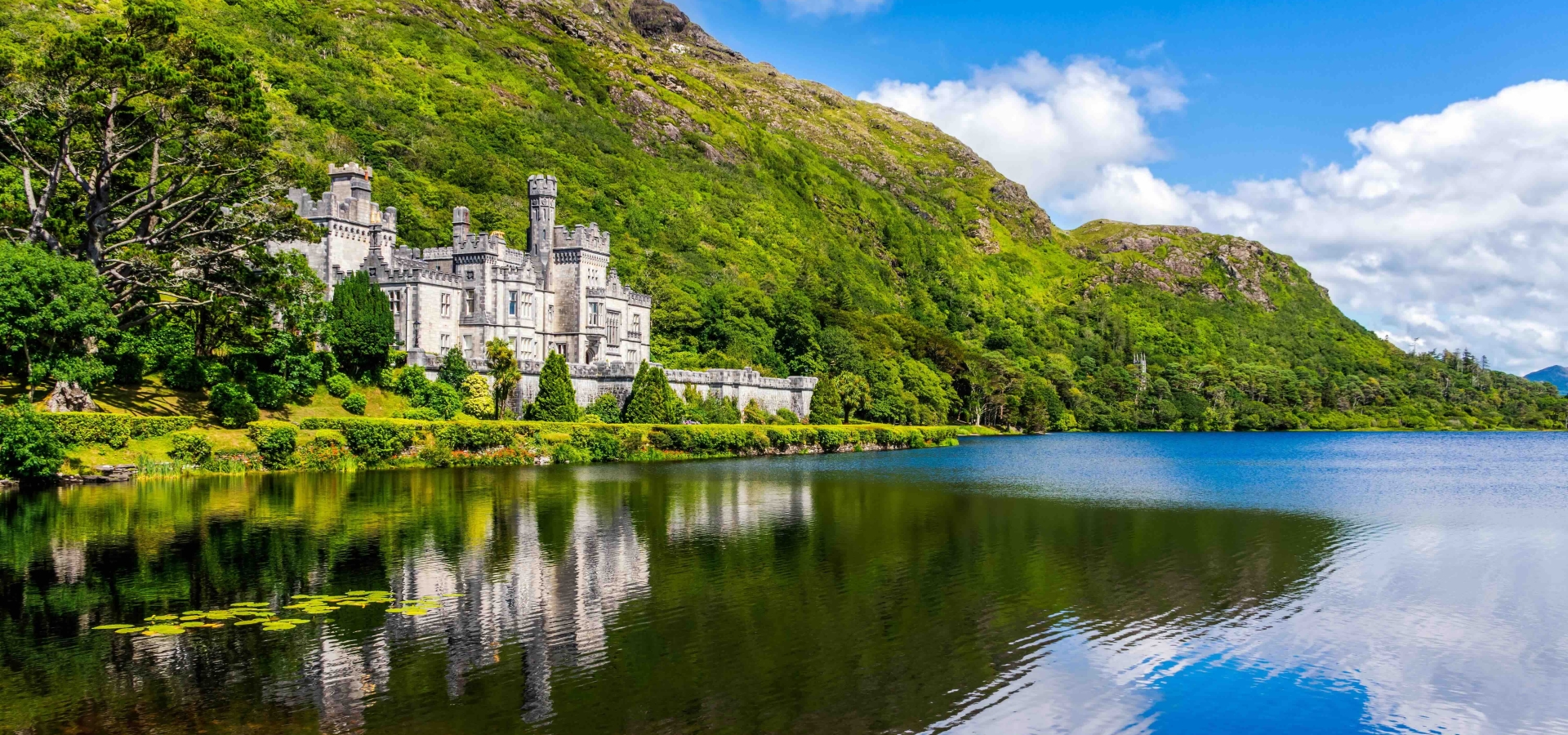 Kylemore Abbey, beautiful castle like abbey reflected in lake at the foot of a mountain. Benedictine monastery founded in 1920, in Connemara, Ireland
