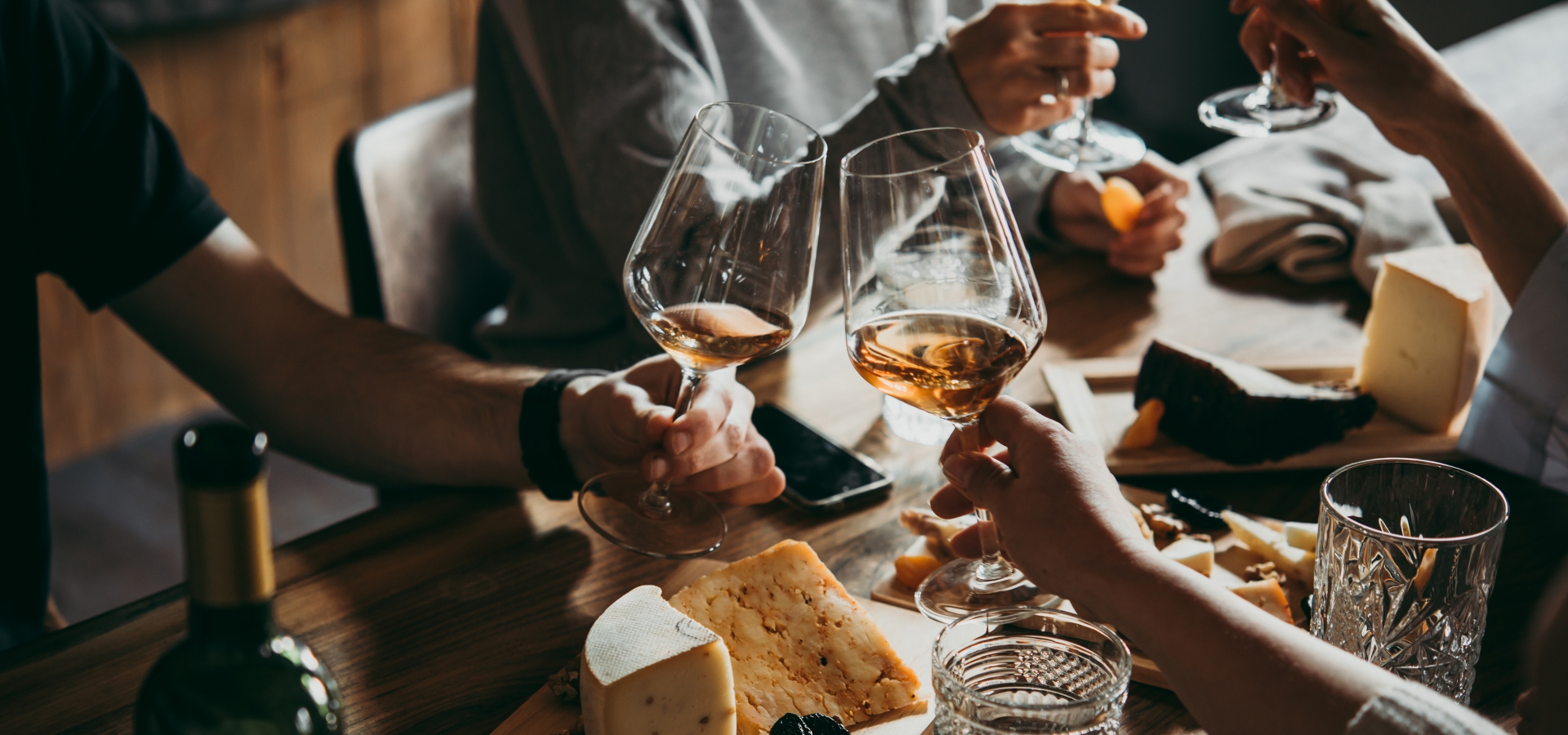 Wine, french bread, and cheese served for a friendly party in restaurant in France