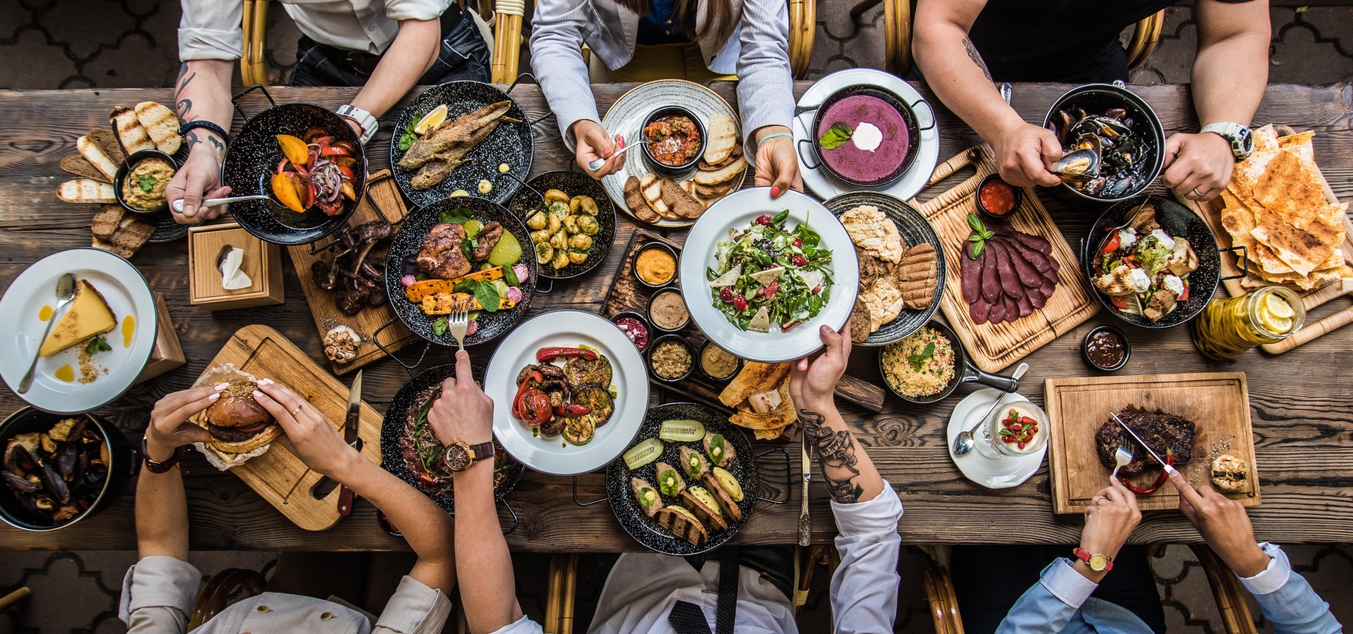 group sitting at table of food