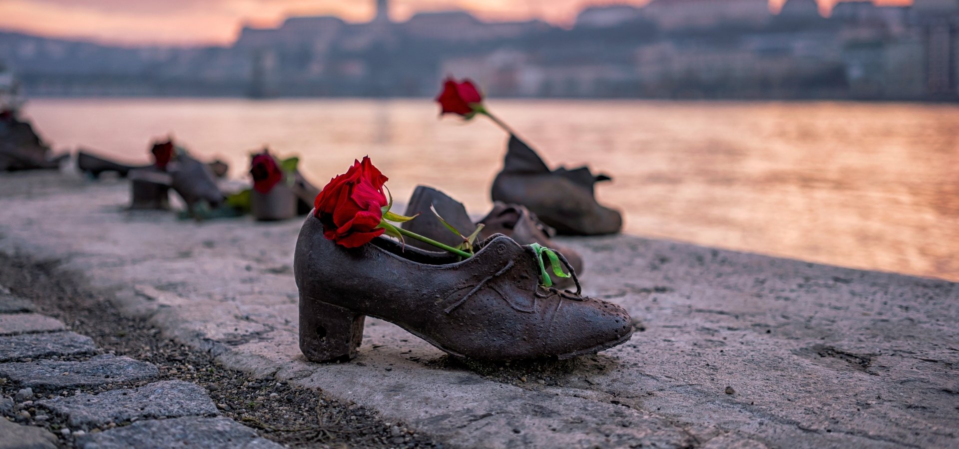 "Shoes on the Danube bank" - Monument as a memorial of the victims of the Holocaust during WWII on the bank of the Danube at sunset in Budapest, Hungary