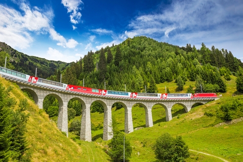 The Glacier Express travels over a viaduct The Glacier Express travels over a viaduct
