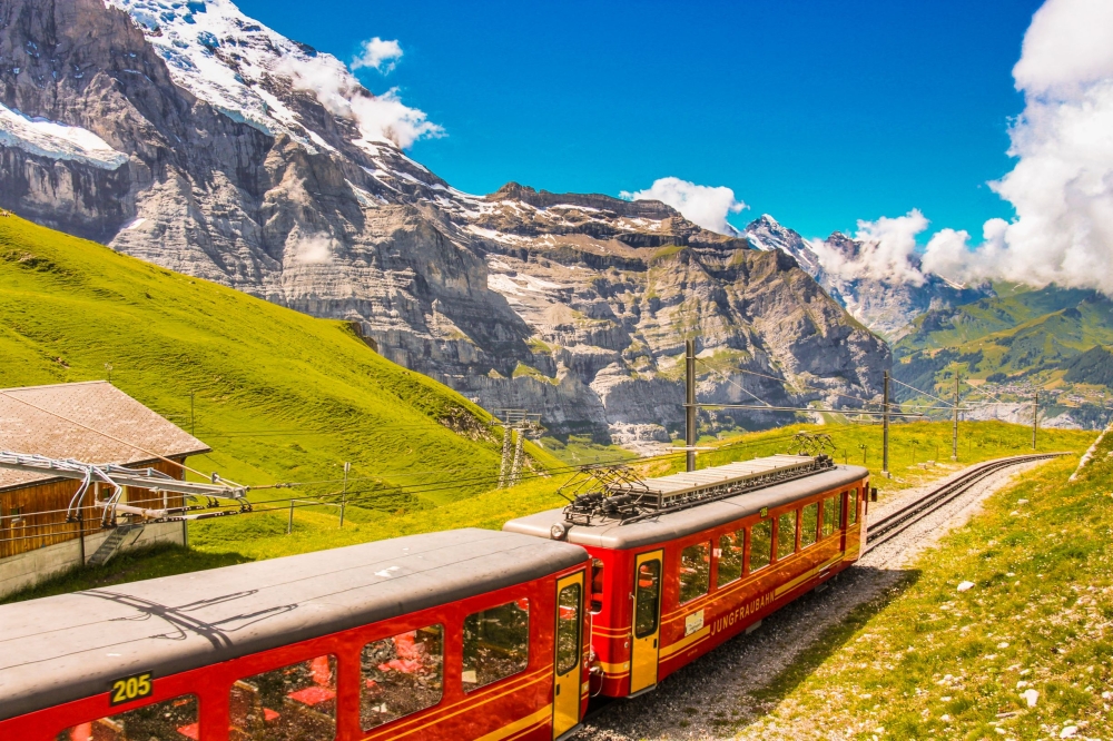 The Jungfrau Railway A train travels through Alpine landscape up a mountain