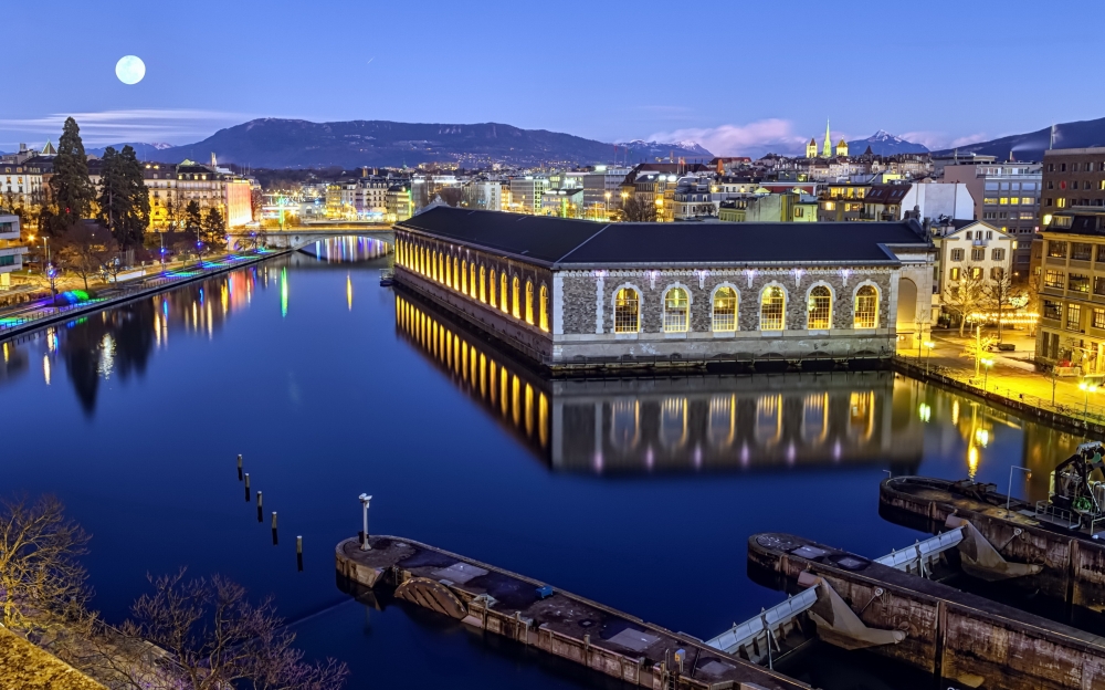 cathedral Saint-Pierre green tower and Rhone river by night with full moon, Geneva, Switzerland